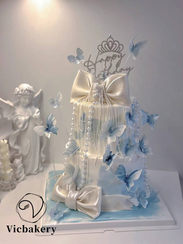 2 tier blue fondant ribbon cake