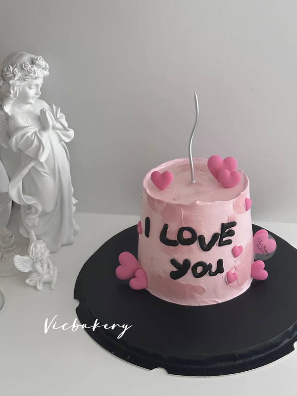 Pink cake with pipe and decorated with 3d heart