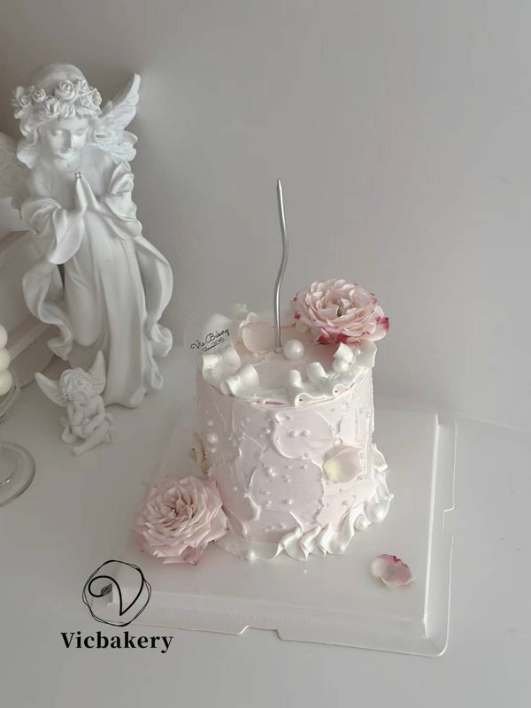 Pink cake with two Flowers and pipe
