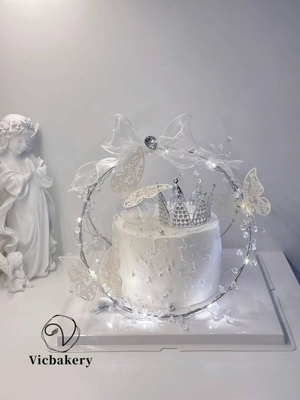 Snow white cake with crown and butterflies