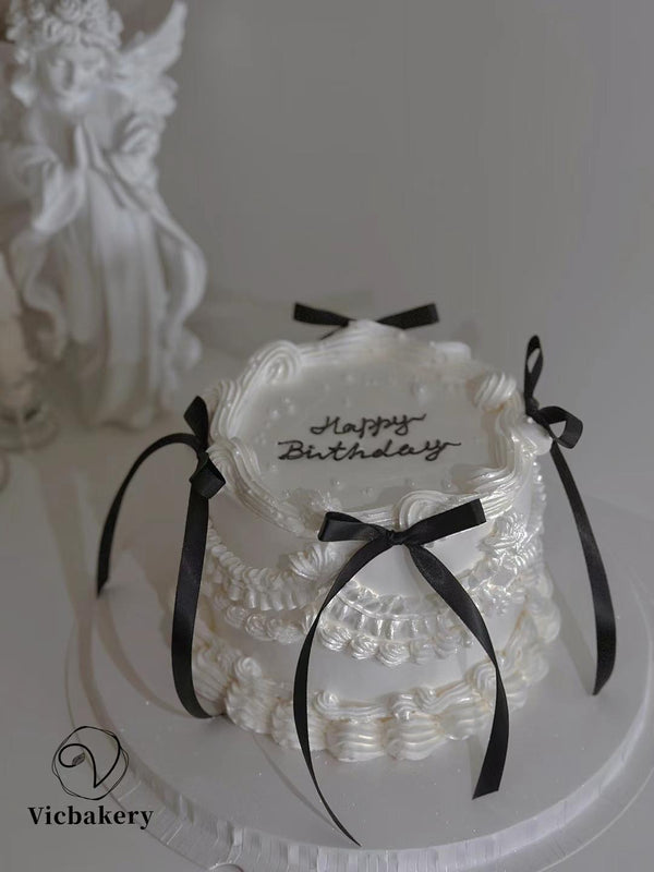 White cake with black silk bow